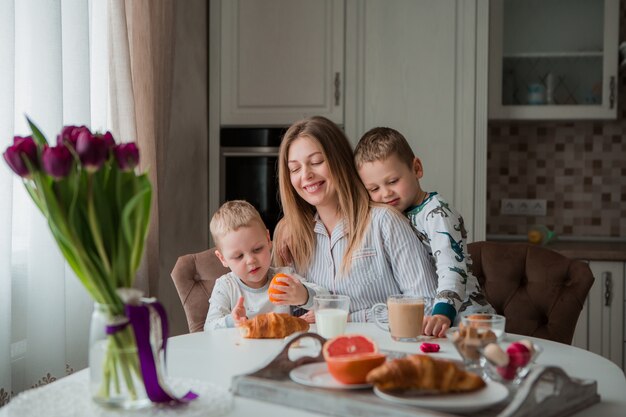 mother with children having Breakfast in the kitchen