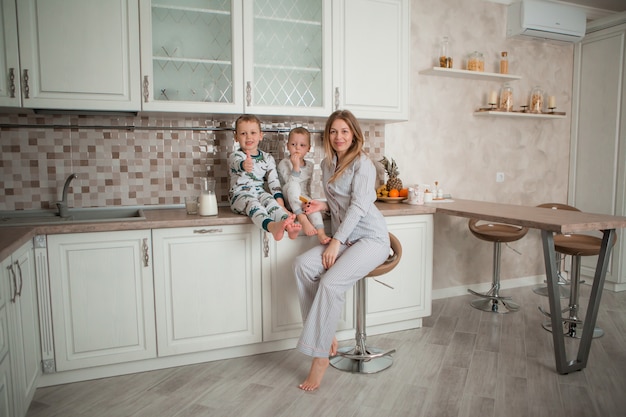 mother with children having Breakfast in the kitchen