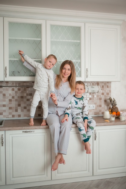 Mother with children in the kitchen