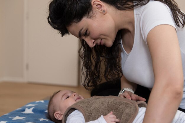 Mother With Cute Little Baby in the Living Room