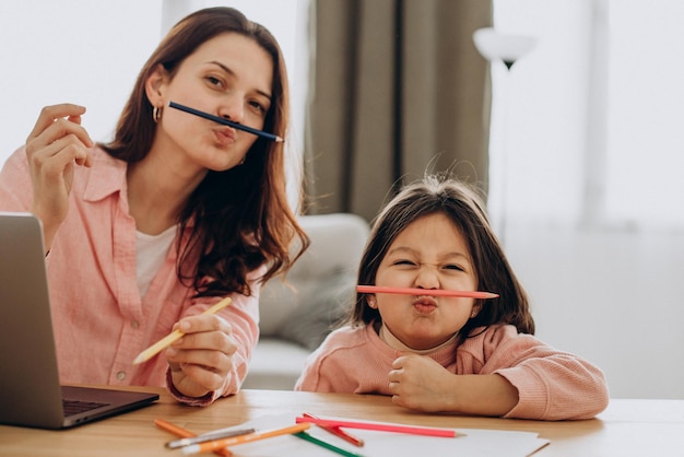 Mother with daughter studying at home