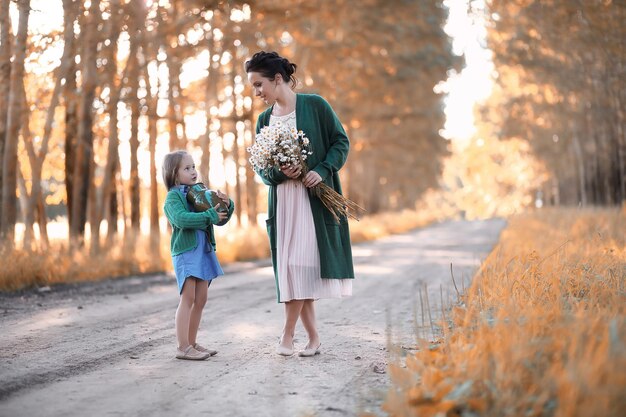 Mother with daughter walking on a road