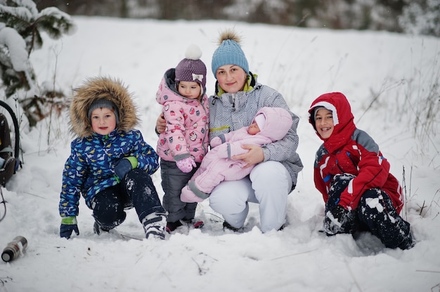 Mother with four kids at winter day.