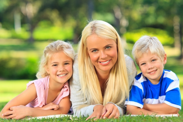 Mother with her children lying down during the summer