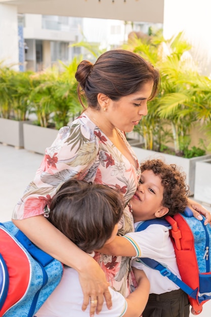 Mother with her children saying goodbye to go to school