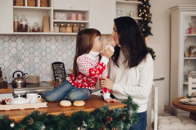 Mother with her daughter in the kitchen