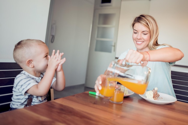 Mother with her happy little child in kitchen