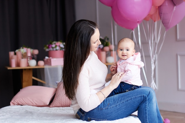 Mother with her little baby in bedroom