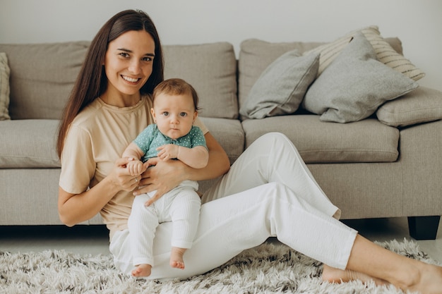 Mother with her little baby girl at home