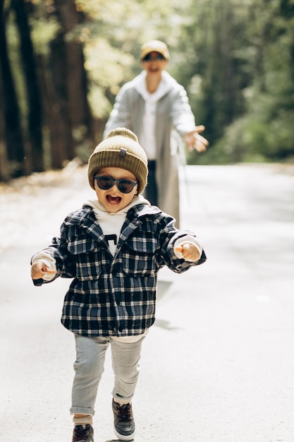 Mother with her little son having fun together in park