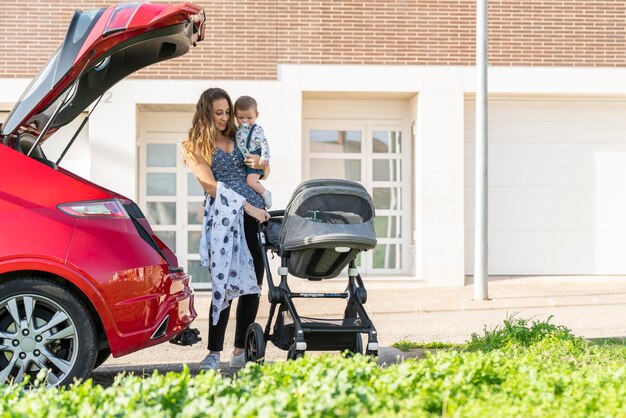 Mother with her son behind the car preparing the trip