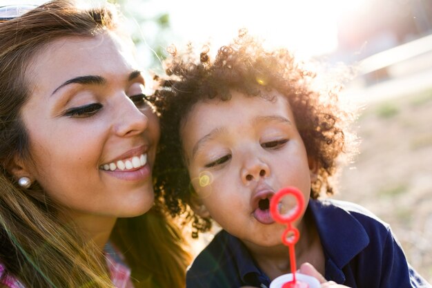 Mother with her son making soap bubbles