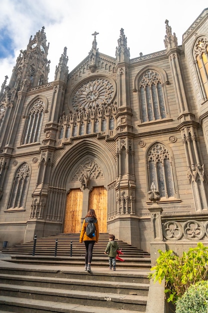 A mother with her son visiting the Church of San Juan Bautista Arucas Cathedral Gran Canaria Spain