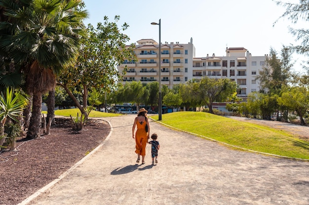 A mother with her son walking through Los Cristianos on the island of Tenerife Canary Islands