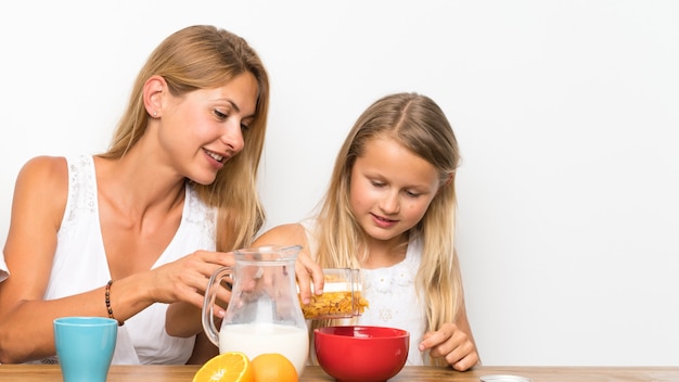 Mother with her two children having breakfast