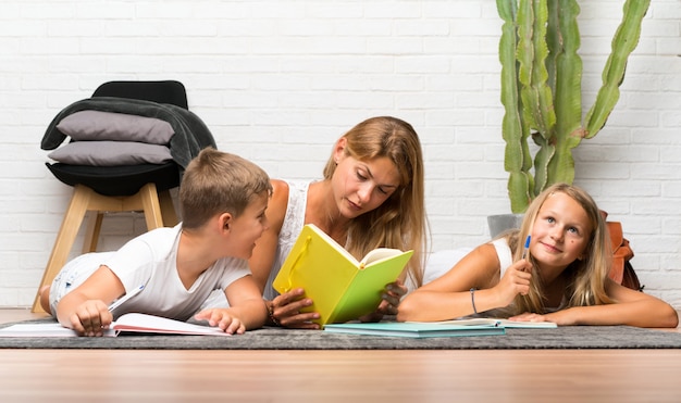 Mother with her two children at indoors and studying