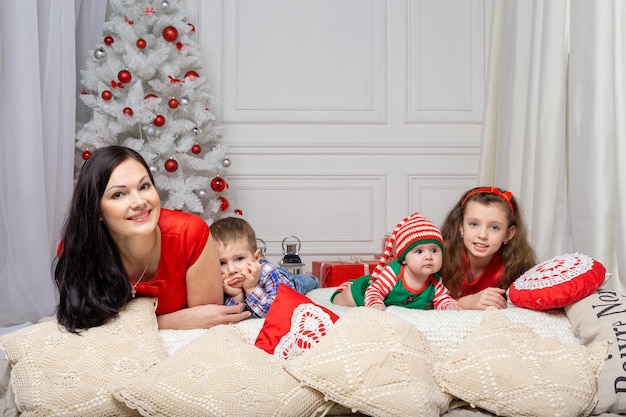 Mother with kids in a Christmas photo session