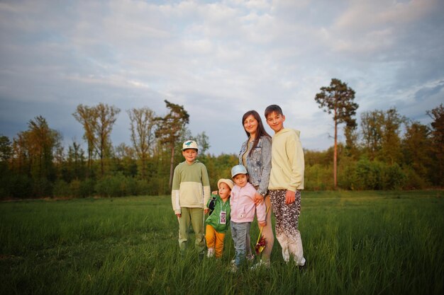 Mother with kids having fun together at meadow