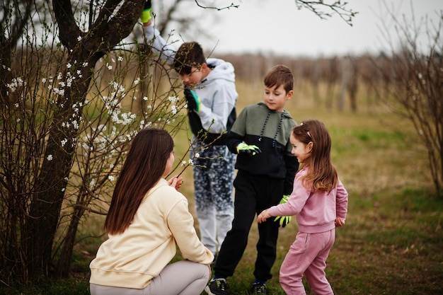 Mother with kids working in spring garden