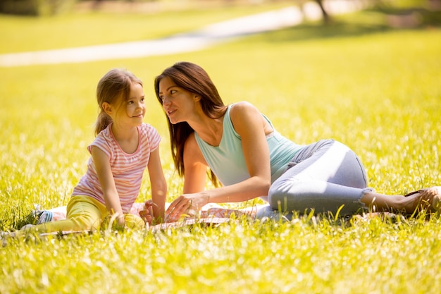 Mother with little daughter having fun in the park on a sunny day