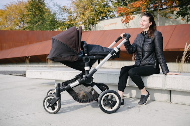 Mother with a pram or stroller on modern city streets