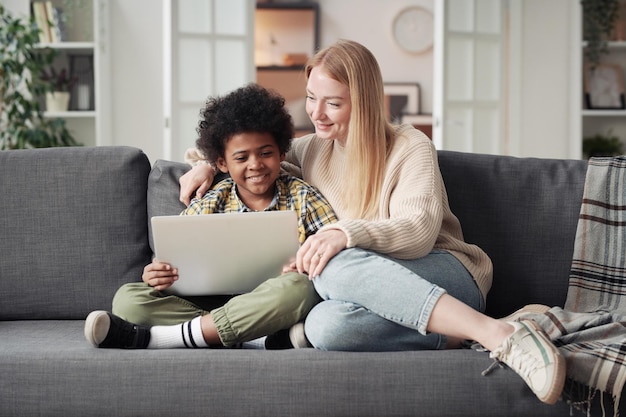 Mother with son using laptop at home