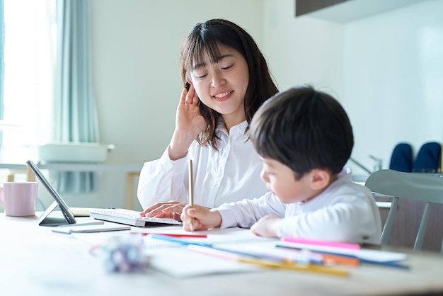 A mother working and a child drawing