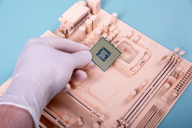 Motherboard and ruaka holding a microprocessor on a blue background in paint