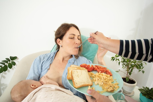 Aiuto di sostegno alla maternità per mangiare alla giovane madre