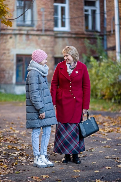 Mothers and daughter walk in the autumn city