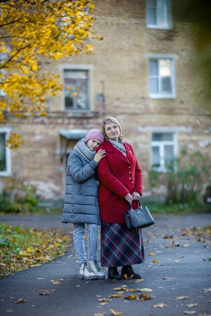 Mothers and daughter walk in the autumn city