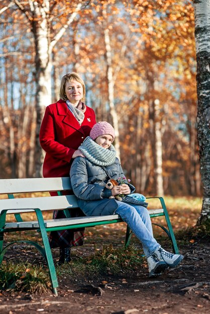 Mothers and daughter walk in the autumn park