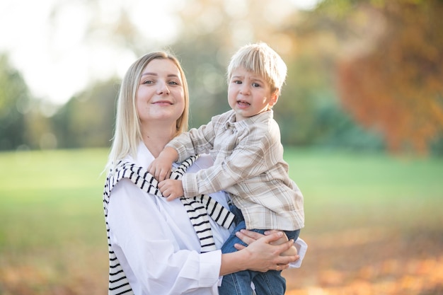 Mothers day love family Family on autumn walk in nature outdoors Mother and child with hugging tenderness