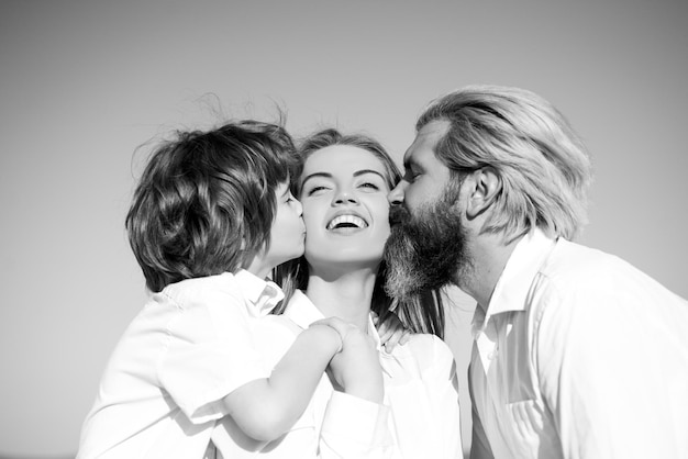 Mothers day parenting happy family motherhood fatherhood son and dad kiss mother young family with c