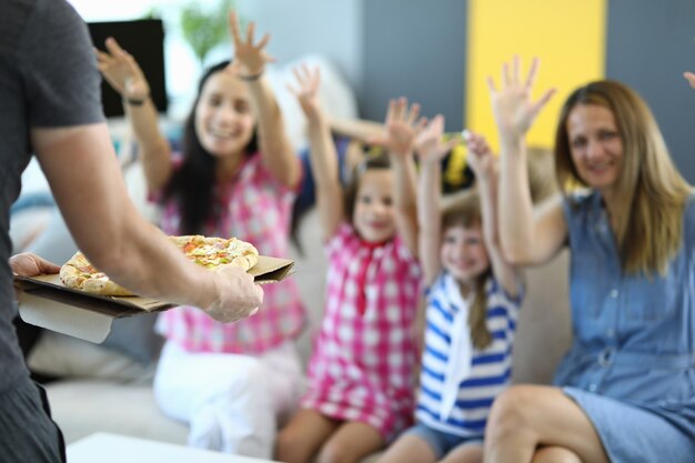 Mothers and girls happy to receive pizza