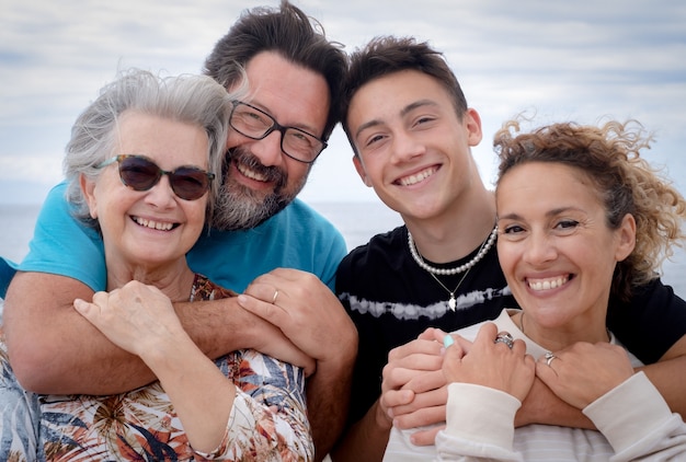 Mothers and sons, multi-generation family smiling embracing each other. Concept of love and happiness