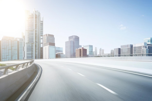 Motion blur flyover asphalt road with modern skyscraper building background