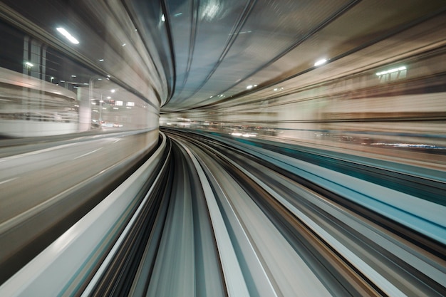 Motion blurred of train moving inside tunnel with daylight in tokyo Japan