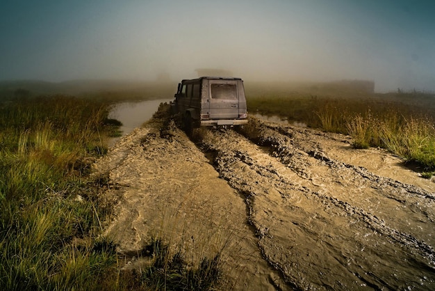 Motion the wheels tires and offroad that goes in the dust off road vehicle coming out of a mud hole ...