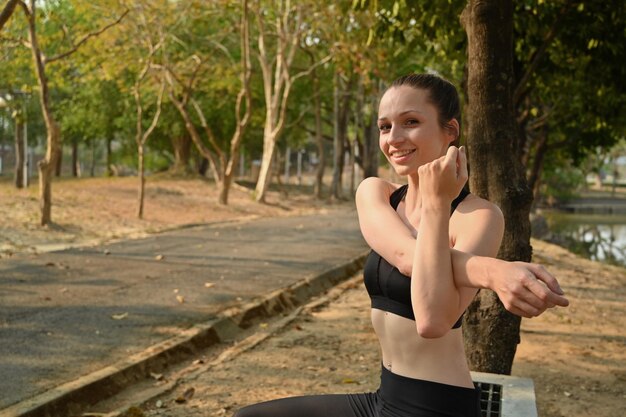 Motivated sporty woman warming up before morning workout Fitness sport and healthy lifestyle concept