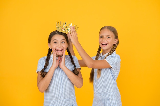 Motivation to be the best small egoist girls imagine they are princess success reward happy childhood frienship retro look of selfish kids vintage girls in gold crown Beauty is not enough