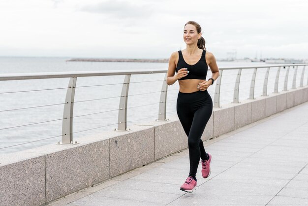 Motivation women engaged in fitness train A person runner using a smartwatch for fitness sportswear