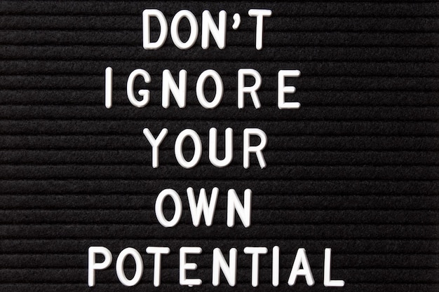 Photo motivational quote on black letter board don't ignore your own potential inspirational quote of the day