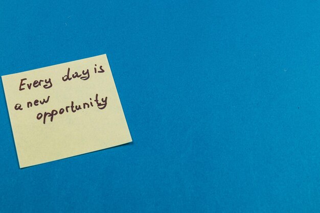 motivational sticky note on blue reminding us of daily chances