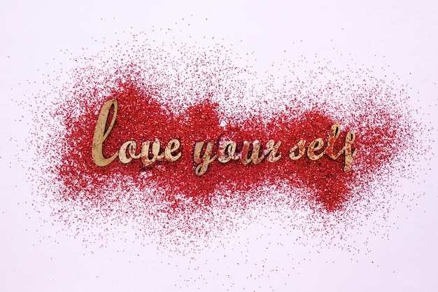 Foto scrittura motivazionale su glitter rosso