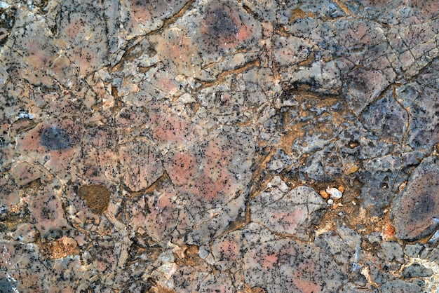 Фото Пестрая текстура старого камня для абстрактного фона или обоев
