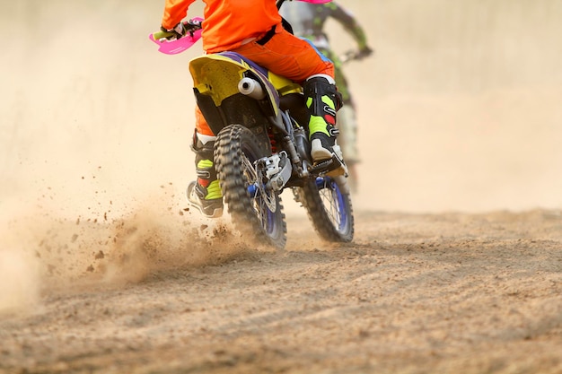 Motocross racer accelerating speed in track