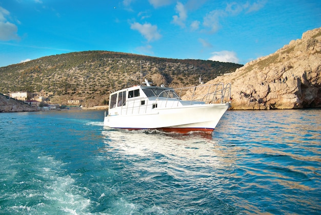 Motor boat cruising the sea near coast. Seascape