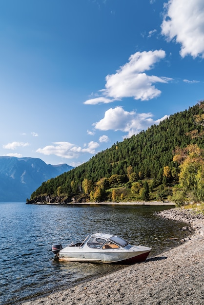 Motor boat moored to shore of mountain lake russia altai lake teletskoye tract cordon chiri