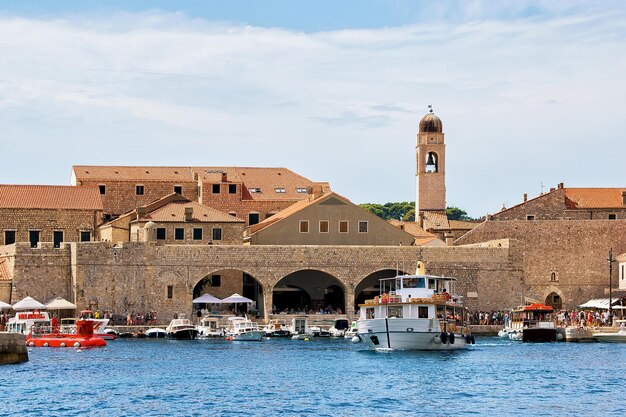 Motor boat at the Old port in the Adriatic Sea in Dubrovnik, Croatia. People on the background